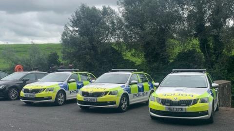 three police cars parked in a row