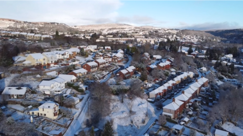 Snowy aerial view of homes in Torfaen county