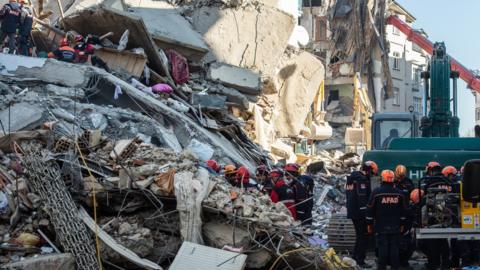 Rescue workers work at the scene of a collapsed building on 26 January 2020 in Elazig, Turkey.