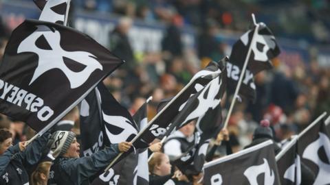 Ospreys flags being waved by fans