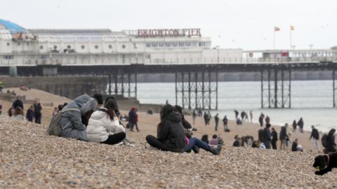 People on Brighton beach, East Sussex