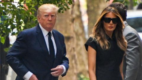 Former President Donald Trump arriving at the funeral with Melania