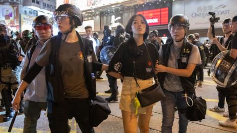 A woman is detained by police on 7 September 2019 at a protest in Hong Kong