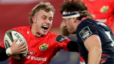 Munster scrum-half Craig Casey is challenged by Edinburgh's Hamish Watson