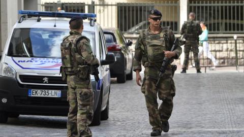 Soldiers at the scene where French soldiers were injured by a car in the western Paris suburb of Levallois-Perret, 9 August 2017