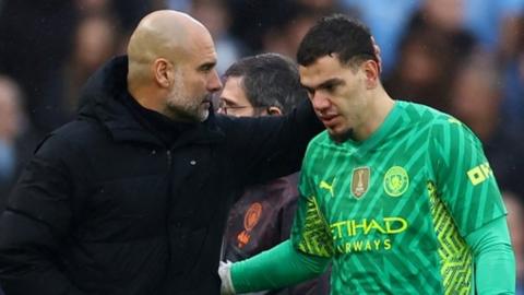 Ederson is consoled by Pep Guardiola as he is substituted following an injury