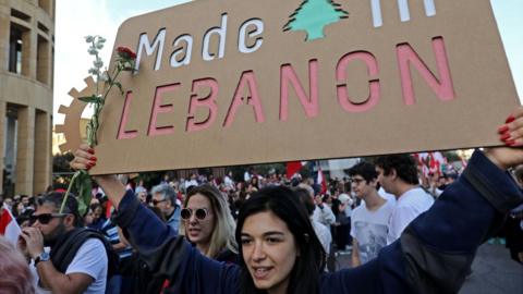 Lebanese demonstrators take part in a civilian Independence Day parade in Beirut's Martyr Square on November 22, 2019,