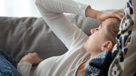 Tired woman lying on a sofa