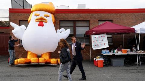 Supporters of Democrat Ralph Northam displayed a cartoon chicken made to resemble Trump outside a polling place in Virginia