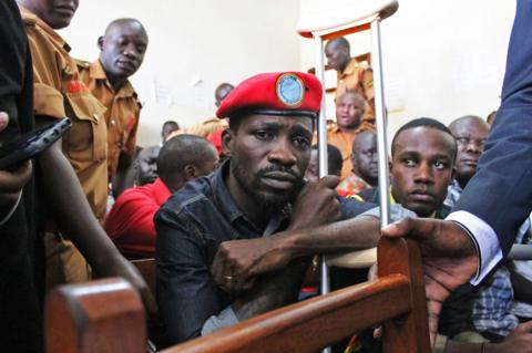 Bobi Wine in court holding a crutch