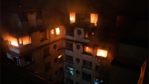 This handout picture taken and released by the Paris firefighters brigade in the night of February 5, 2019 shows a fire in a building in Erlanger street in the 16th arrondissement in Paris, that killed 8 people.