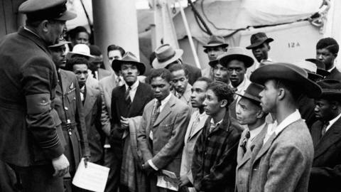 Jamaican (West Indian) immigrants welcomed by RAF officials from the Colonial Office after the ex-troopship HMT "Empire Windrush" landed them at Tilbury