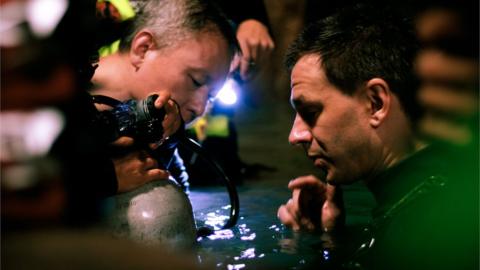 Cave divers Tan Xiaolong and Jim Warny preparing for a scene