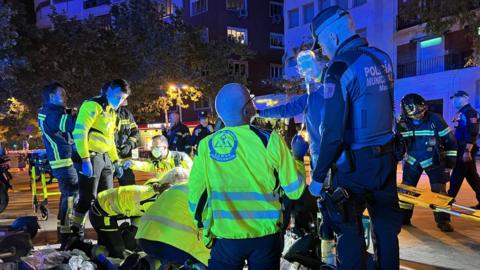 Health workers and police tend to injured people in Madrid