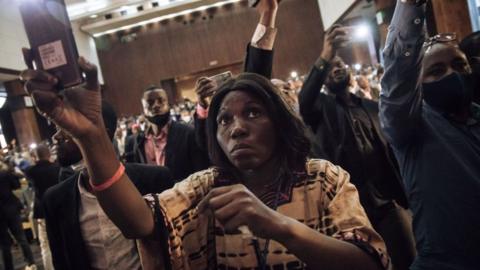 Journalists and supporters of the presidential party record the installation of the temporary board of the Parliament of the Democratic Republic of Congo, in Kinshasa on December 8, 2020