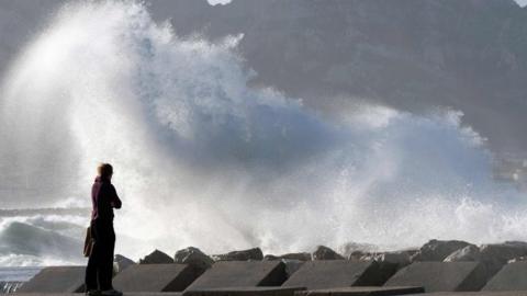 Man watches waves at beach in Marseille, France - 4 January