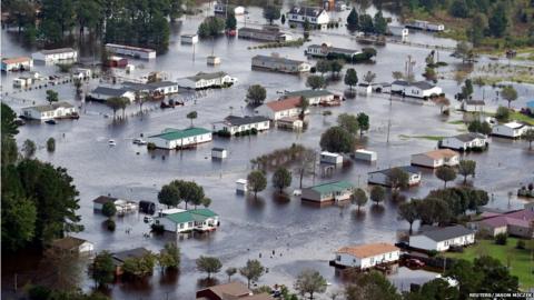 Houses sit in floodwater