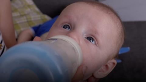 baby drinking from bottle