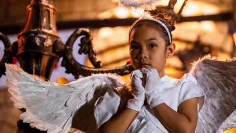 A child dressed as an angel gestures before the traditional procession where the images of Jesus Christ and Mary meet, on Easter Sunday, at the St. Peter Parish Shrine of Leaders in Quezon City, Metro Manila, Philippines