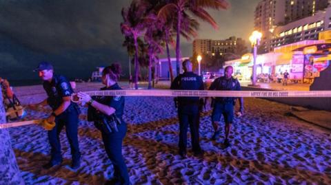 Police officers close off the area where gunfire broke out along a beach boardwalk in Hollywood, Florida, USA, 29 May 2023. A City of Hollywood spokesperson confirmed 9 people were transported to area hospitals with gunshot wounds.