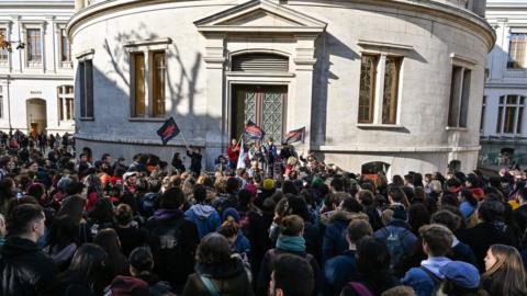 Students gather inside the campus of Lyon 2 building in Lyon on November 12, 2019 during a demonstration called by French students union Solidaires days after a 22-year-old student set himself on fire over financial problems.