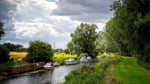 A general view of barges and boats on the River Great Ouse near Southery, Cambridgeshire
