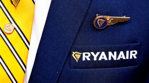 A Ryanair badge and embroidered crest on the jacket of an employee