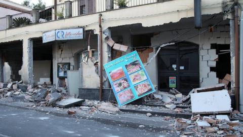 Shops are seen damaged by an earthquake, measuring magnitude 4.8, at the area north of Catania