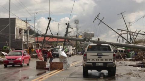 Telephone poles knocked over onto the street