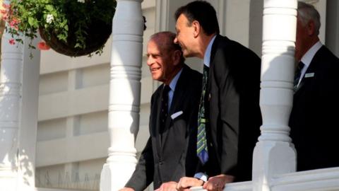 Prince Philip, Duke of Edinburgh watches play from a balcony