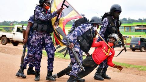 Ugandan riot police detain a supporter of presidential candidate Robert Kyagulanyi, also known as Bobi Wine, in Luuka district, eastern Uganda, 18 November 2020