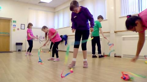 Children at dance class with ribbons