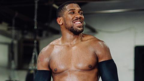 Anthony Joshua smiles during training camp in Texas