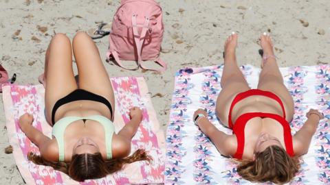 Two women on a beach at Ghadira Bay, Malta