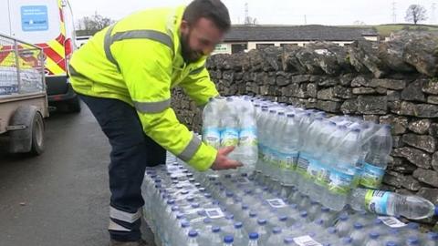 Bottled water being handed out in Shap