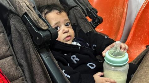 A Palestinian boy, who has a skin infection, looks on at a hospital, amid doctors warning of the spread of diseases and infections among Gazan children due to the ongoing conflict between Israel and Hamas, in Rafah, in the southern Gaza Strip on 12 December 2023