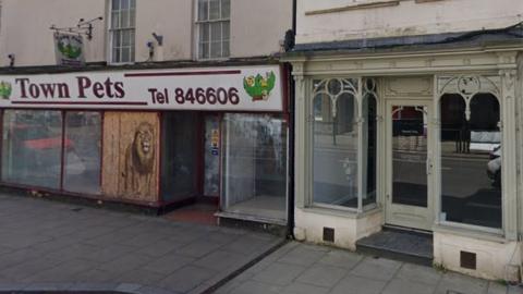 Two empty shop fronts in Warminster, including an old pet shop