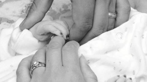 The parents' hands with Wynter