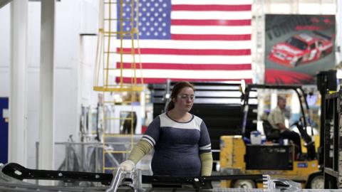 worker handle parts for Fiat Chrysler Automobiles as they come off the press at the FCA Sterling Stamping Plant August 26, 2016 in Sterling Heights, Michigan.