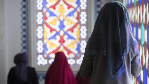 A Muslim woman is seen during midday prayers at a mosque in Berlin