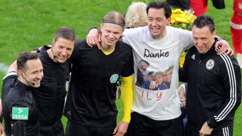 Erling Braut Haaland with the match officials