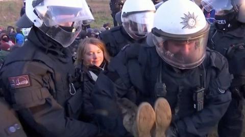 Greta Thunberg being carried by police