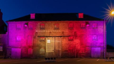Sommerfeld & Thomas building in King's Lynn illuminated at night