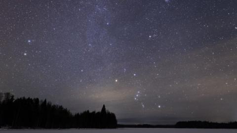 The Orion constellation above frozen lake
