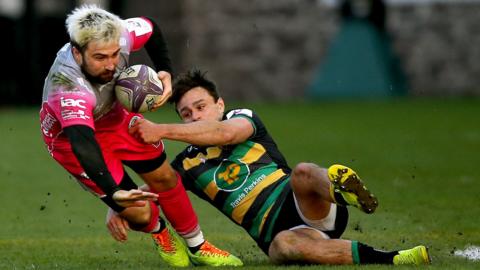 Northampton match-winner Tom Collins hauls down Dragons' Jordan Williams