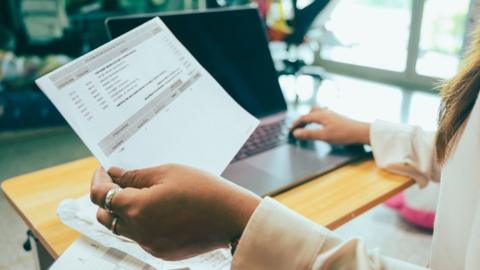 Stock shot of person looking at financial documents