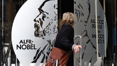 A woman enters the Nobel museum in Stockholm