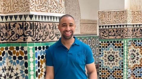 A picture of Aza Lemmer standing in front of colourful tiles in Marrakesh before the earthquake.