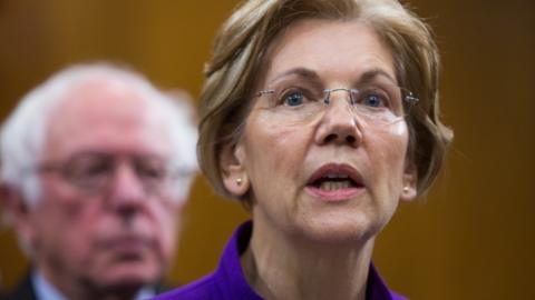 Elizabeth Warren and Bernie Sanders appear together at a news conference.