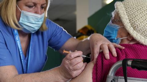 A NHS worker administers the Covid-19 vaccine at Totally Wicked Stadium, home of St Helen's rugby club, one of the new mass vaccination centres